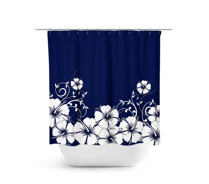 Shower curtain with navy blue background and white hibiscus flowers and vines on the bottom half of the curtain. The image shows the shower curtain on a curtain rod over a white bathtub.