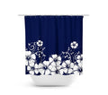 Shower curtain with navy blue background and white hibiscus flowers and vines on the bottom half of the curtain. The image shows the shower curtain on a curtain rod over a white bathtub.
