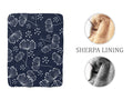 Sherpa fuzzy blankt with white dandelions scattered on a navy blue background
