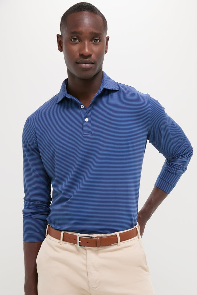 Young man models the Navy Lyons Performance Jersey Long Sleeve Polo, featuring a classic, effortless style with high-end, functional details for fun, confident wear.