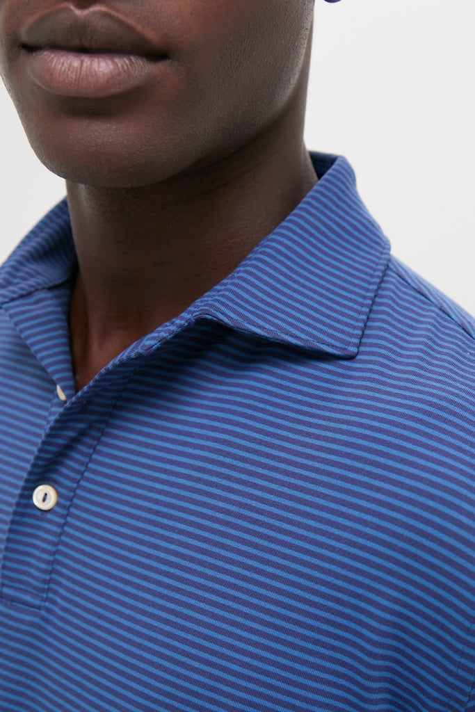 Close-up of a person's lower face wearing the Navy Lyons Performance Jersey Long Sleeve Polo, showcasing a classic, effortless design with high-end performance features like moisture-wicking and UPF 50+.