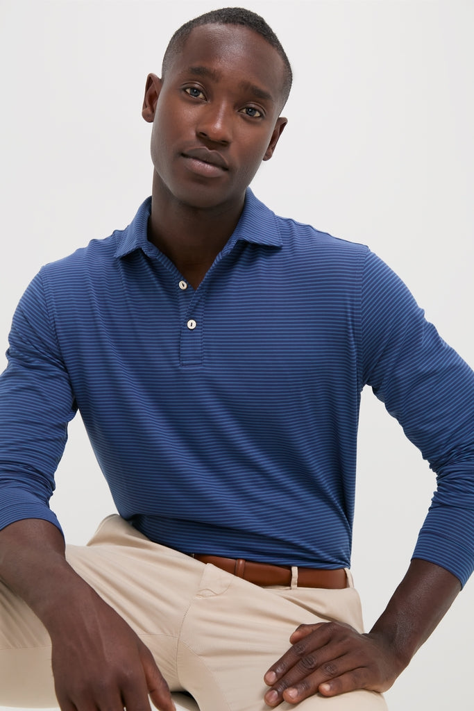 Young man models the Navy Lyons Performance Jersey Long Sleeve Polo, a classic, high-end piece combining effortless style and fun functionality with moisture-wicking and UPF 50+ features.