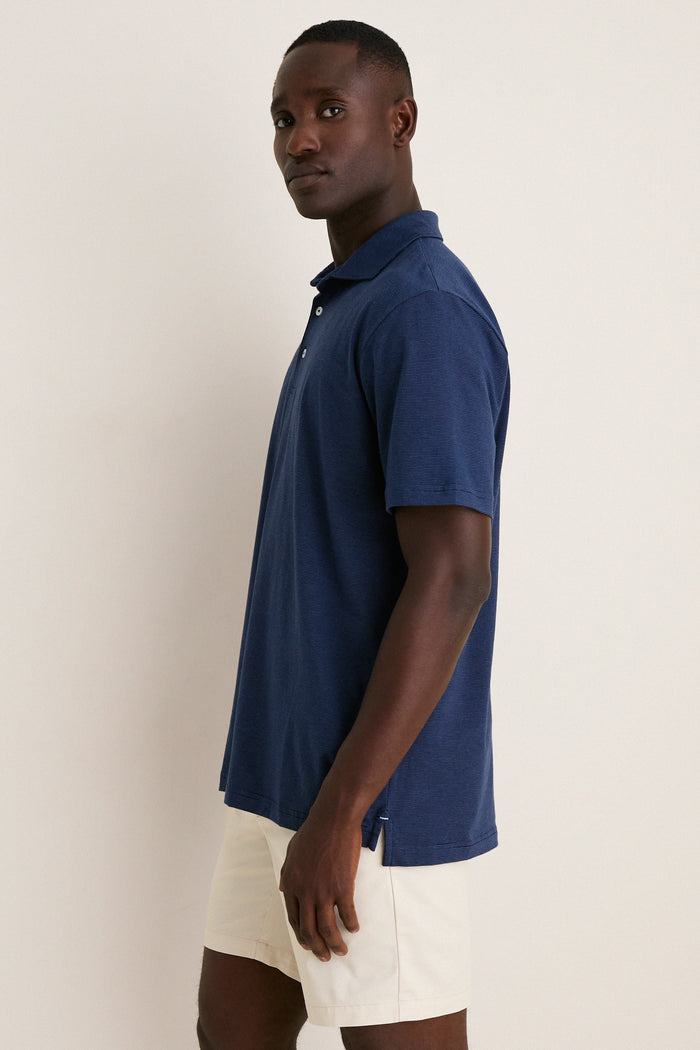 Navy Ryles Crown Flex Cotton Polo on a young man captures a classic, effortless style. This high-end, fun polo features a cutaway collar and streamlined fit.