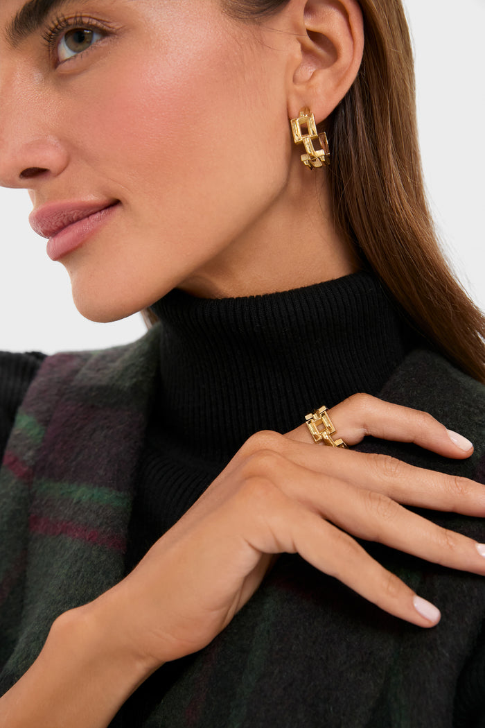 Woman wearing classic Pathway Ring in Gold with interlocking geometric design, paired with matching gold earrings. Effortless, high-end style perfect for any occasion.