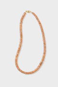 Theodosia circular peach beaded necklace features flat beads and a gold clasp, beautifully handcrafted as fine jewelry.