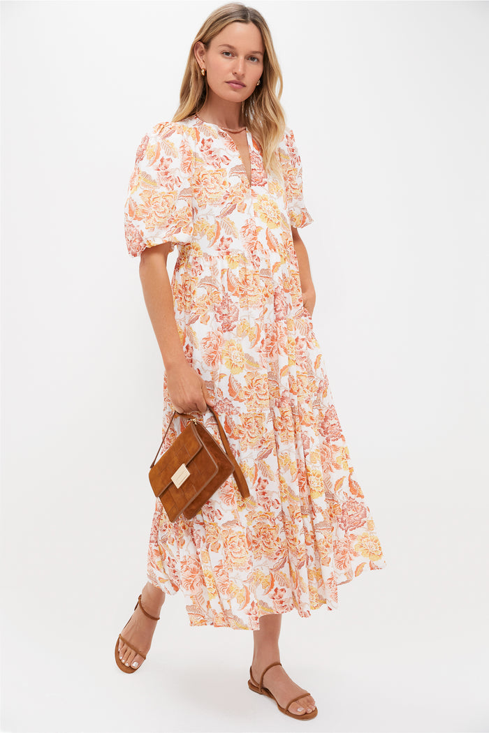 Model wearing an effortless white dress with orange-yellow floral print, accessorized with a classic, high-end Peach Moonstone Candy Necklace, enhancing a fun, confident style.