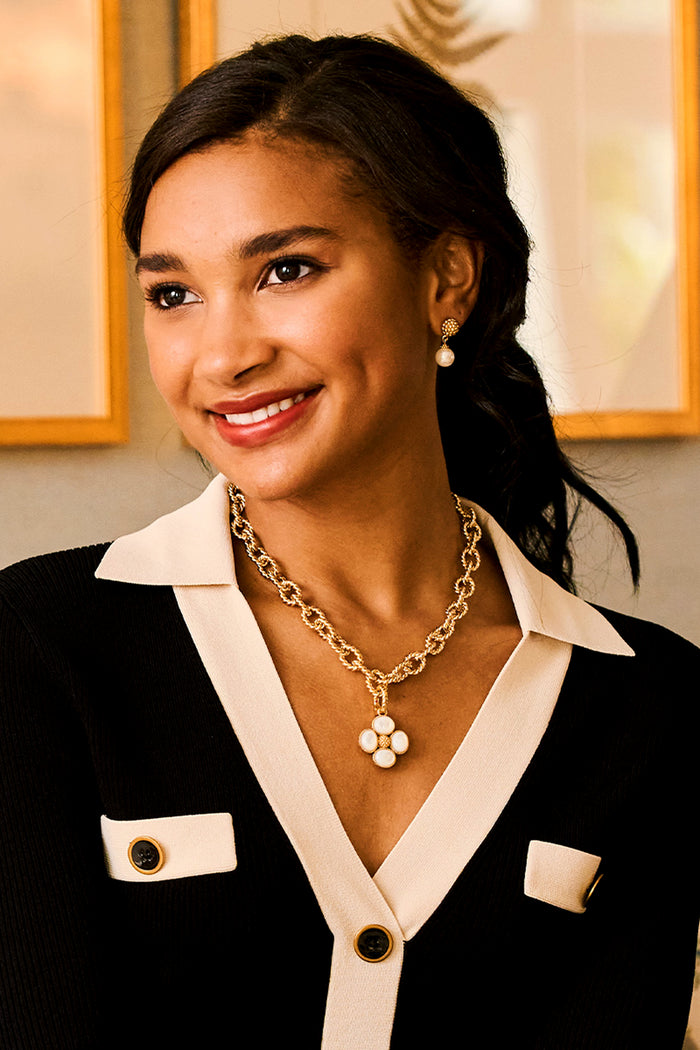Young woman wearing Pearl Berry Drop Stud Earrings, showcasing their classic, effortless shimmer. These fun, high-end earrings enhance her confident, stylish look with a playful touch.