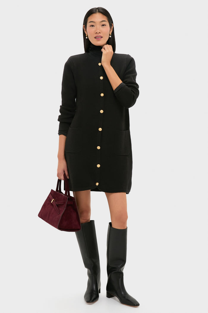 Model wearing classic Pearl Berry Drop Stud Earrings with a black cardigan and knee-high boots, effortlessly styled with a burgundy handbag for a fun, high-end look.