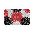 A rectangular memory foam mat with a design of red, black, and gray flower bursts against a white background, featuring an anti-slip backing.