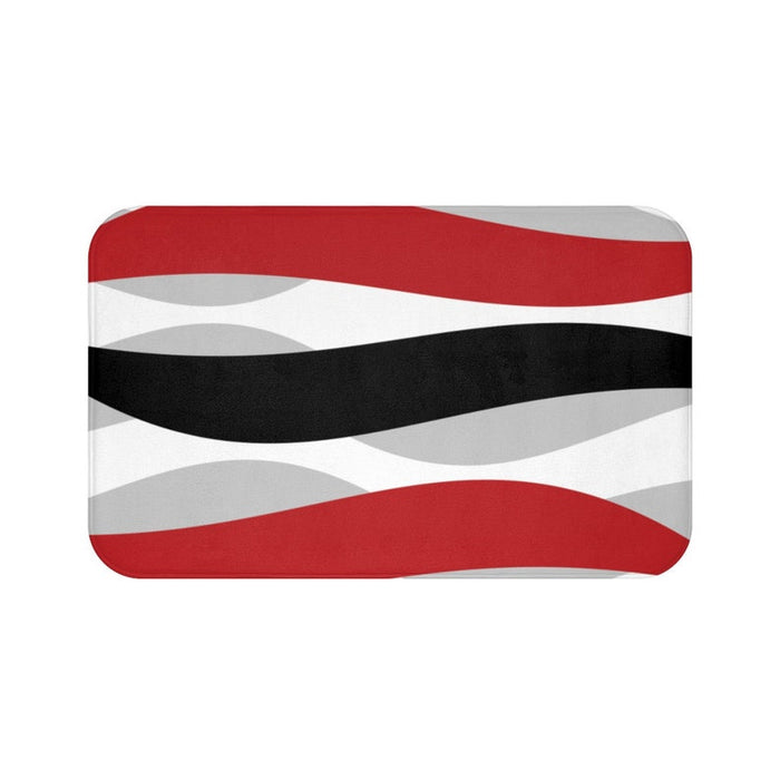 Memory foam mat with geometric waves in red, black, and gray on a white background.