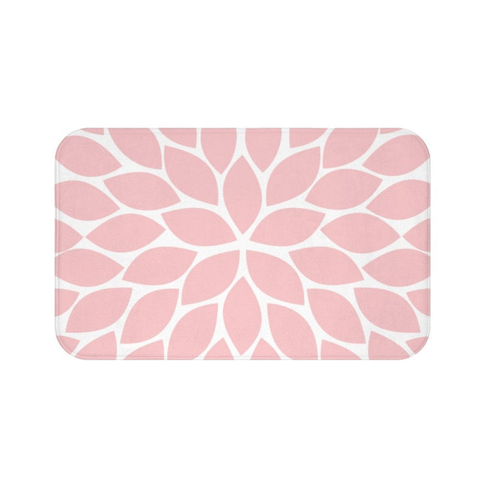 Memory foam floor mat with a single flower petal burst design in baby pink with a white background. The center flower petals form a star pattern with all the other flower petals bursting out from the center.