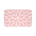 Memory foam floor mat with a single flower petal burst design in baby pink with a white background. The center flower petals form a star pattern with all the other flower petals bursting out from the center.