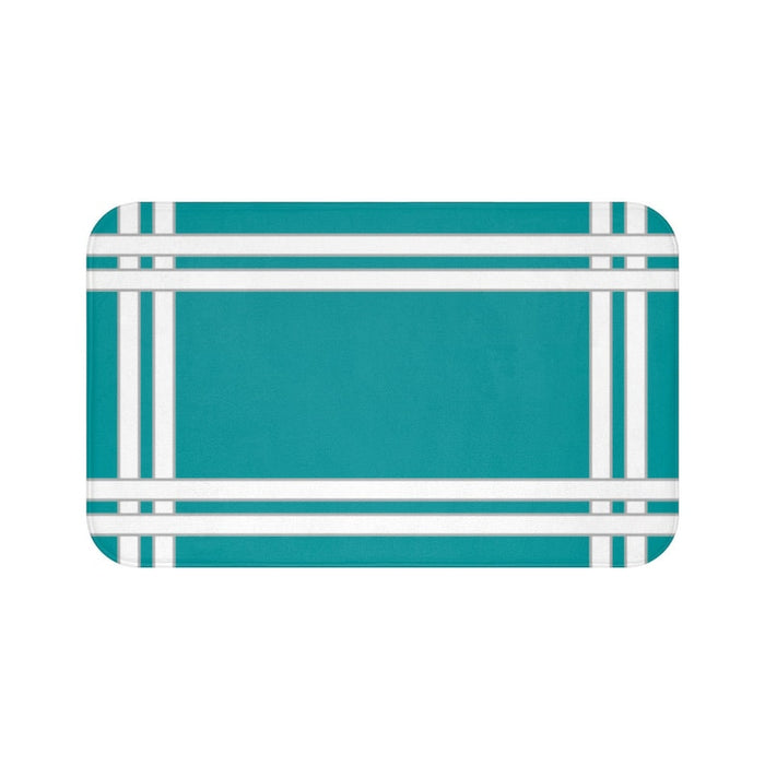 A rectangular solid teal with white borders memory foam mat with a simple geometric pattern.