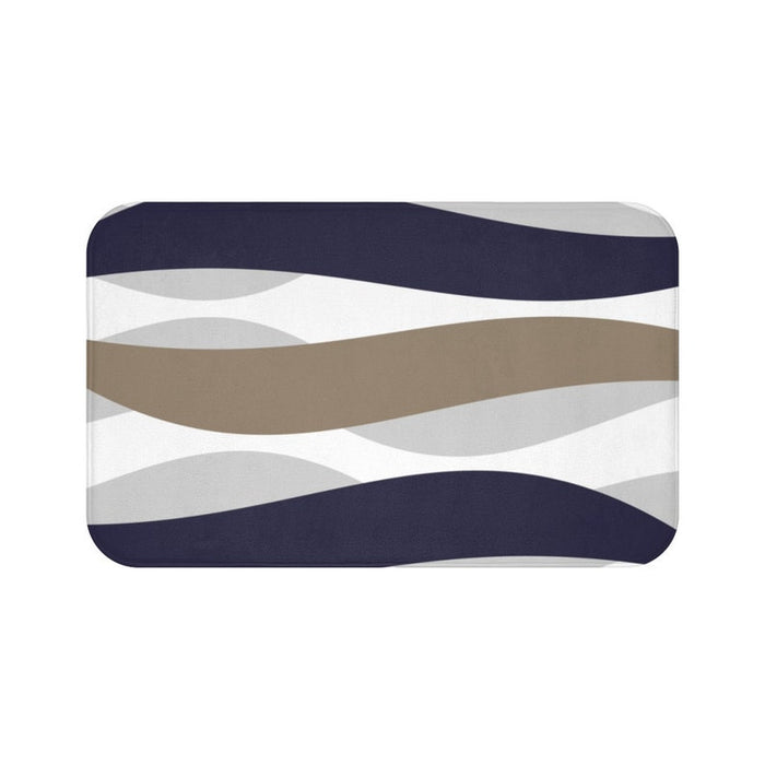 A rectangular memory foam mat with a geometric wave pattern featuring shades of blue, beige, and gray.
