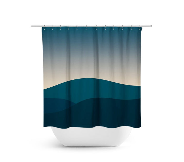 A shower curtain with a teal and navy mountain design, featuring a horizontal rod and hanging loops.