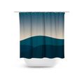 A shower curtain with a teal and navy mountain design, featuring a horizontal rod and hanging loops.