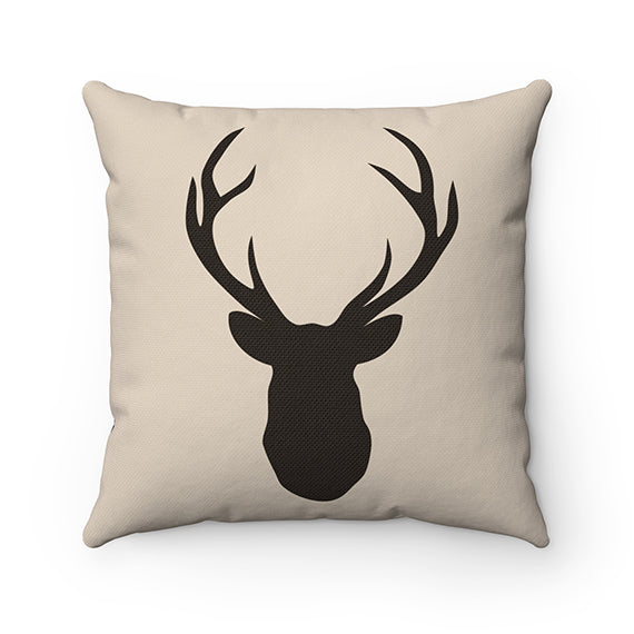 Tan pillow with dark brown silhouette of a deer buck head with antlers.