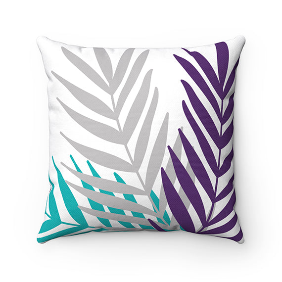 A square-shaped throw pillow with a palm leaves design featuring teal, purple, and gray colors against a white background.