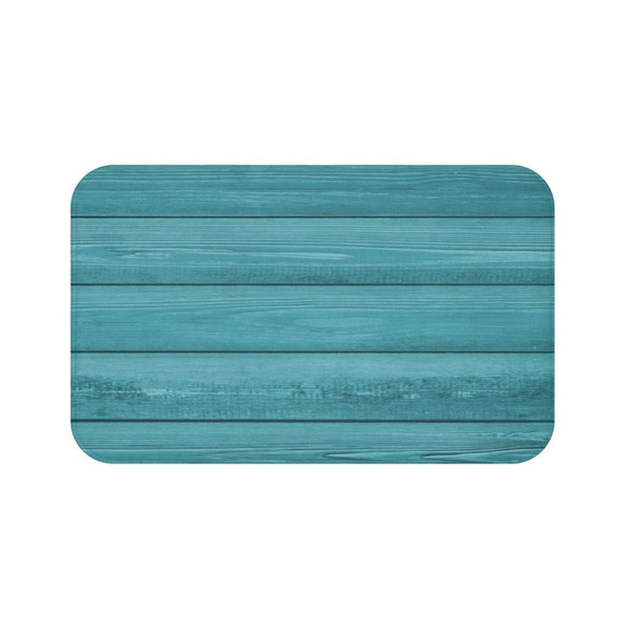 A rectangular, solid teal blue, wood-patterned memory foam mat with anti-slip backing.