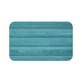 A rectangular, solid teal blue, wood-patterned memory foam mat with anti-slip backing.