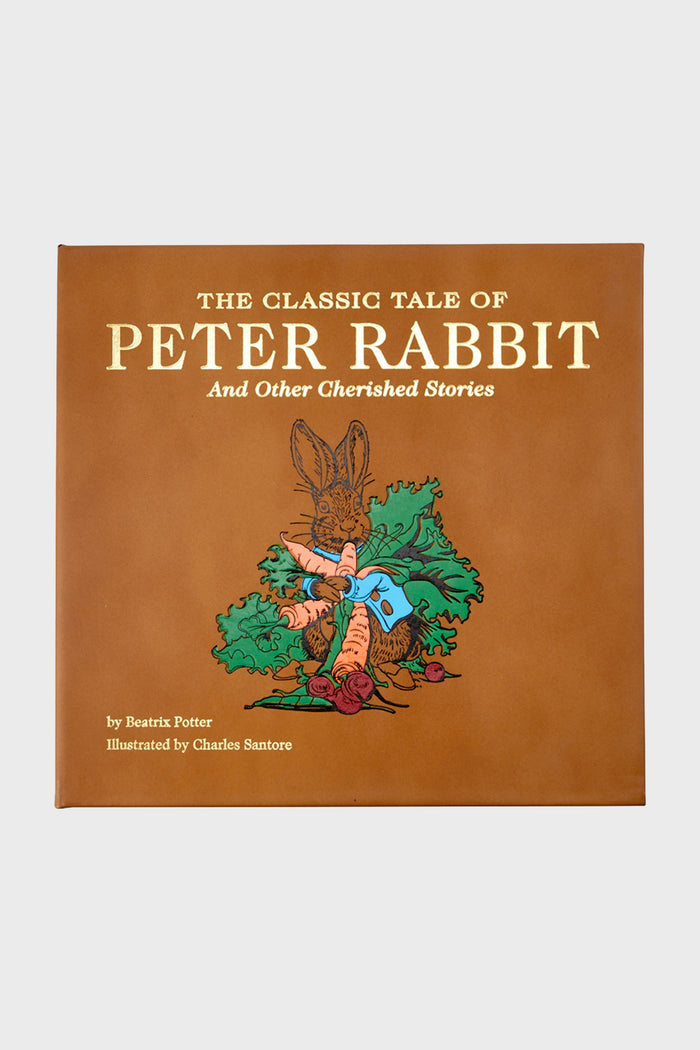 Graphic Image’s brown book cover features The Classic Tale of Peter Rabbit and Other Cherished Stories, authored by Beatrix Potter with original illustrations by Charles Santore.