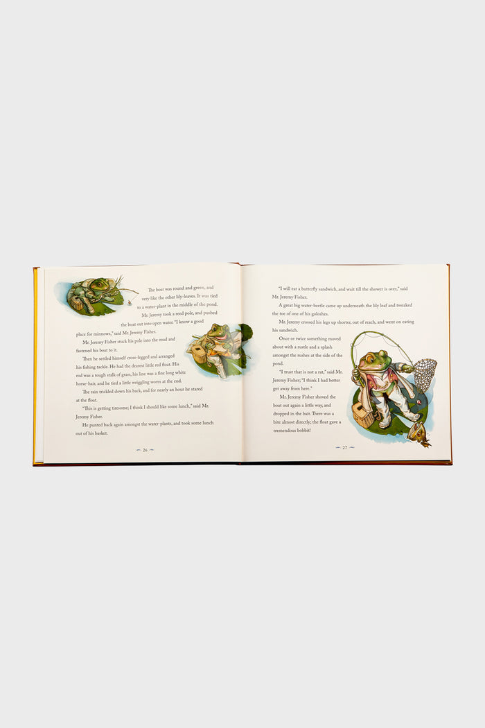 Children's picture book open to Mr. Jeremy Fisher's fishing tale, showcasing classic, effortless, and fun watercolor illustrations, embodying the high-end charm of The Classic Tale of Peter Rabbit.
