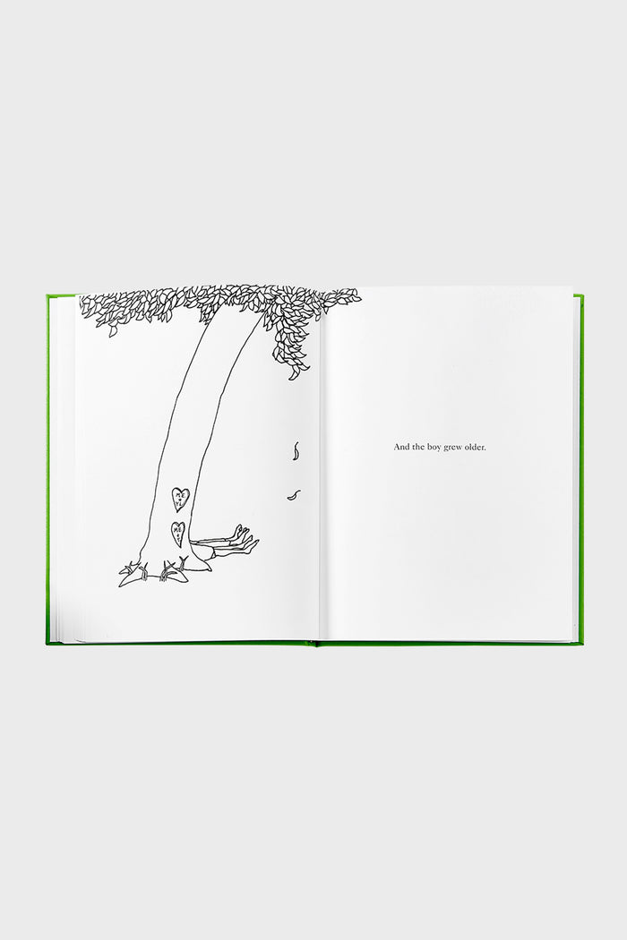 Classic children’s book, The Giving Tree, open to a line drawing of a tree and text, embodying effortless storytelling and high-end design. Fun, timeless reading for all ages.