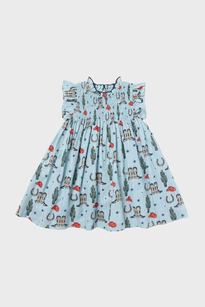 The Pink Chicken Tiny Texas Stevie Dress for girls features ruffled sleeves and a western-themed print with cacti, cowboy boots, hats, and horseshoes in light blue.