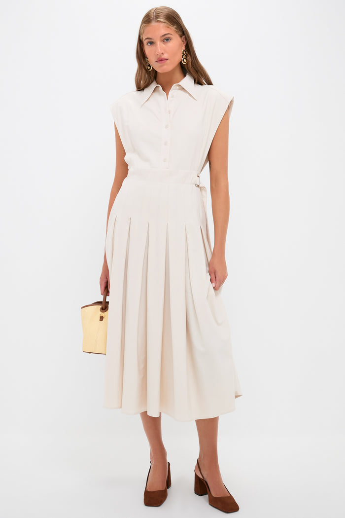 Model showcasing Tortoise 24K Gold Electroplated Circle Drop Earrings, adding a classic, effortless touch to a high-end, fun beige shirt-dress ensemble with chic accessories.
