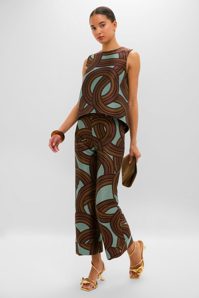 Model showcases an effortless, high-end look with a classic Tortoise Rock Medium Bangle, paired perfectly with an abstract-patterned outfit and chic accessories.