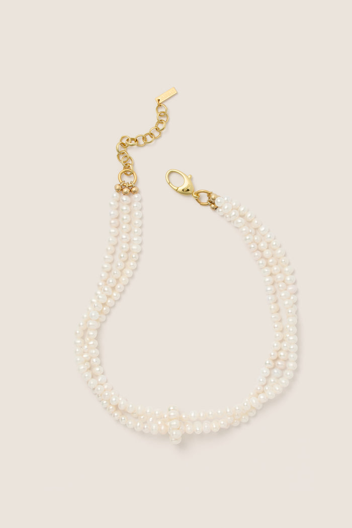 White Freshwater Pearl Dalia Necklace: A classic, effortless multi-strand design with hand-strung pearls and a gold-tone clasp, embodying fun, high-end elegance.